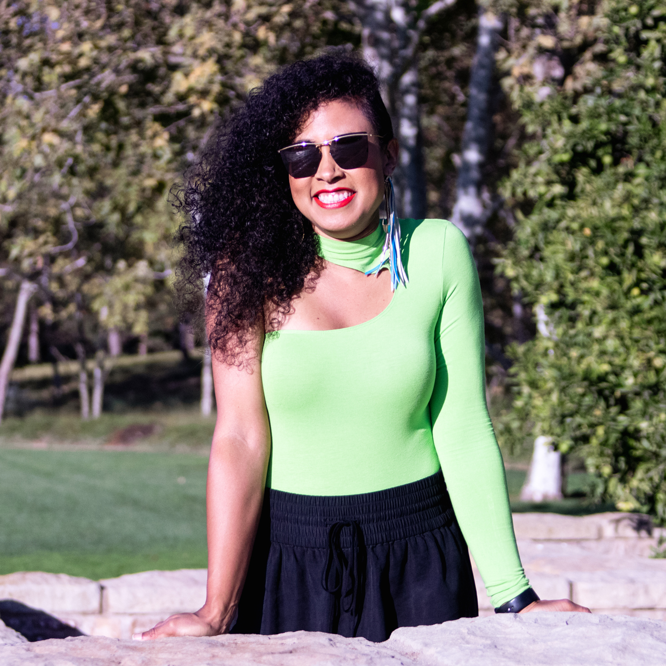 Tayo Joyce Smiles Outside with Sunglasses